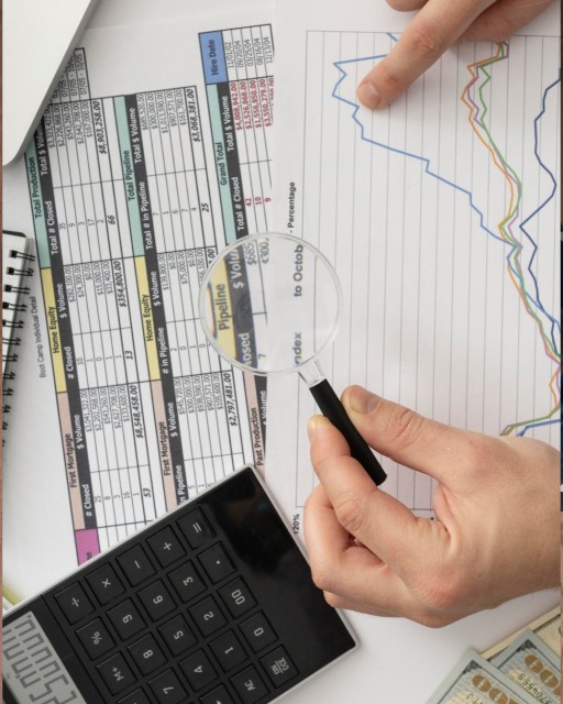 White sports car driving fast on a snowy mountain road with snow-covered hills and a partly cloudy sky.
